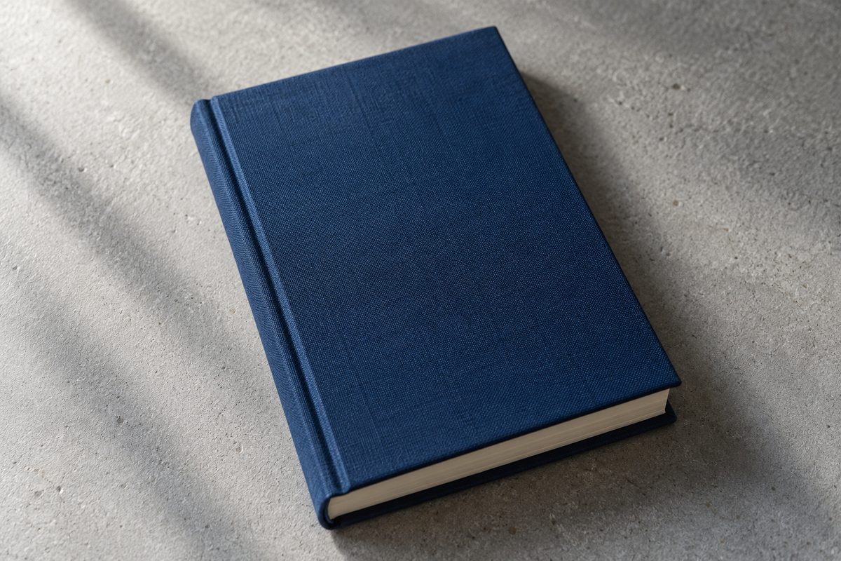 Clothbound volume of The Solitude of Rivers in dark blue bookcloth with blind debossing